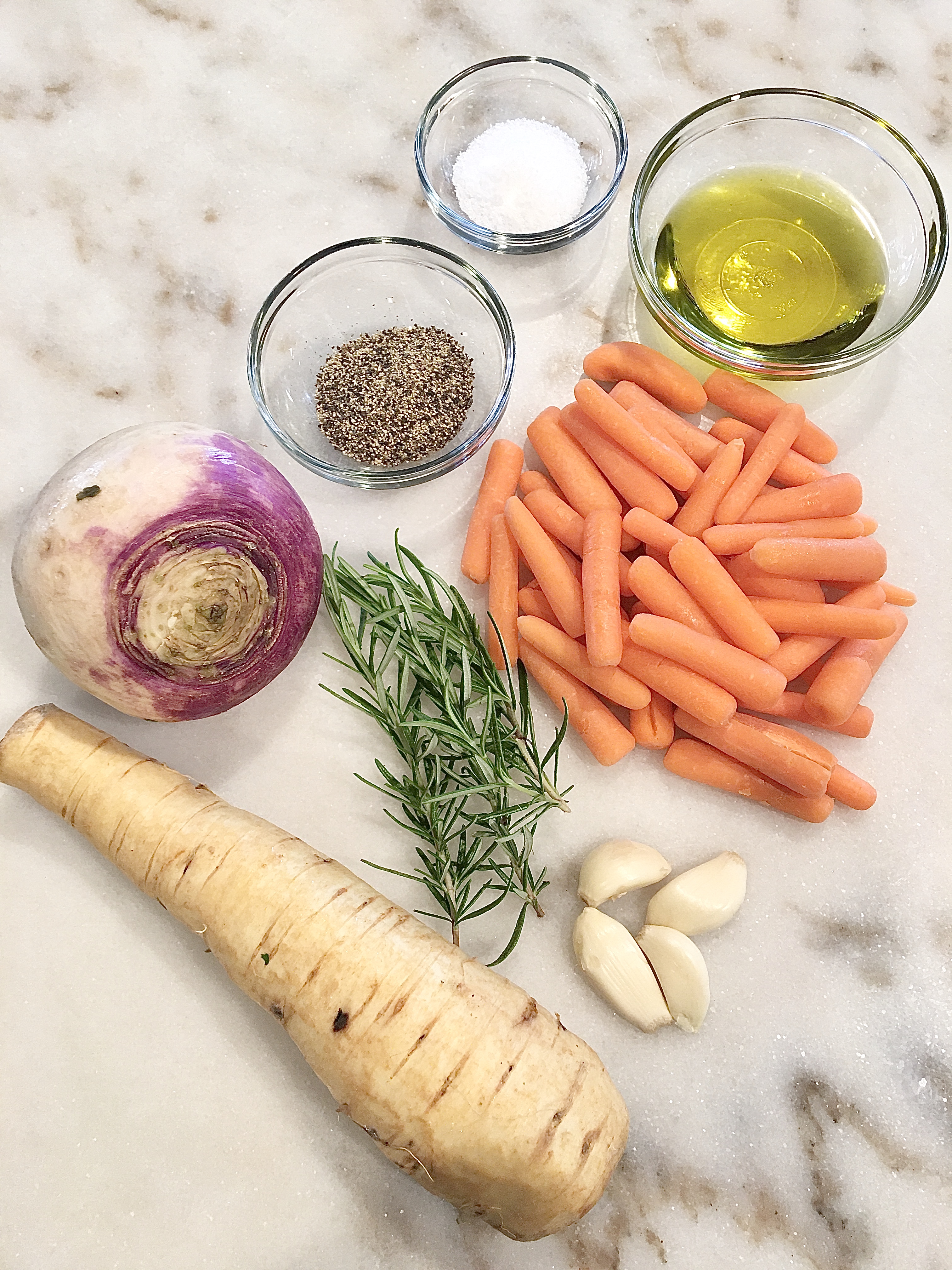 winter root vegetables full of parsnips, turnips, and carrots, fresh rosemary, garlic, pepper, salt, olive oil
