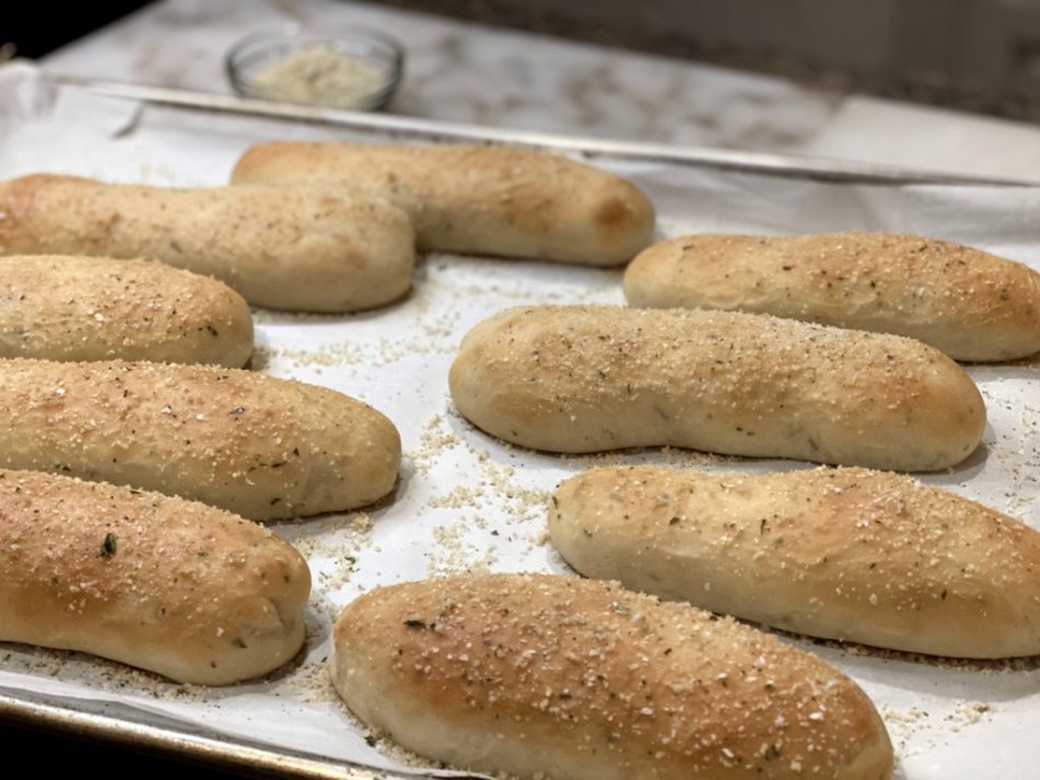 Thick fluffly Garlic Rosemary Breadsticks sprinkled with garlic made with rosemary sprigs