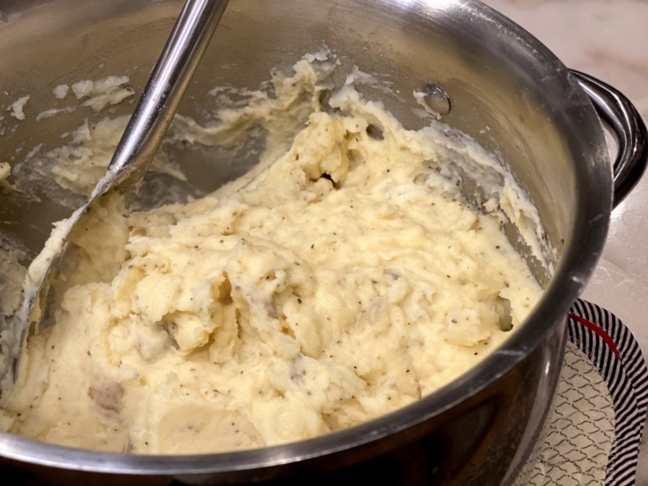 cheddar, milk, and butter mixed in softened mashed potatoes