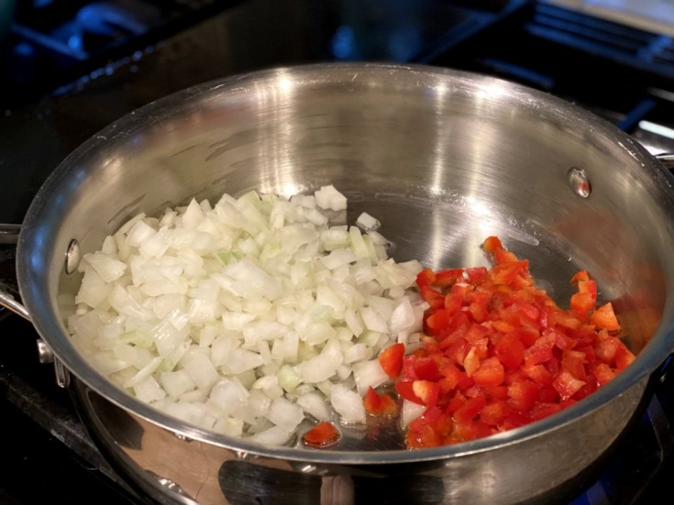 chopped onions and red bell peppers in a large skillet
