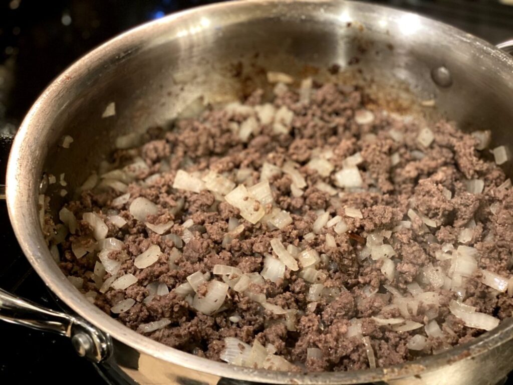 browning ground beef with onions and garlic in a large skillet. 