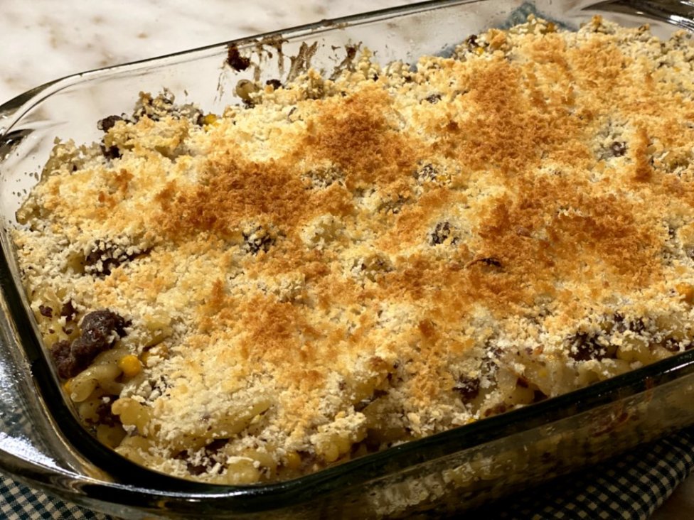 ground beef with noodles, corn, sour cream, cream of chicken soup with bread crumbs browned on top in a glass casserole dish. 