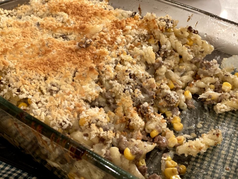 ground beef with noodles, corn, sour cream, cream of chicken soup with bread crumbs browned on top in a glass casserole dish. 
