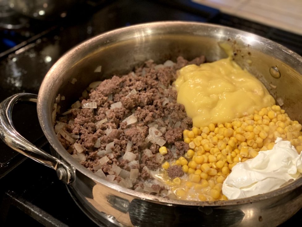 cooked ground beef with onions, cream of chicken soup, corn and sour cream in a large skillet. 