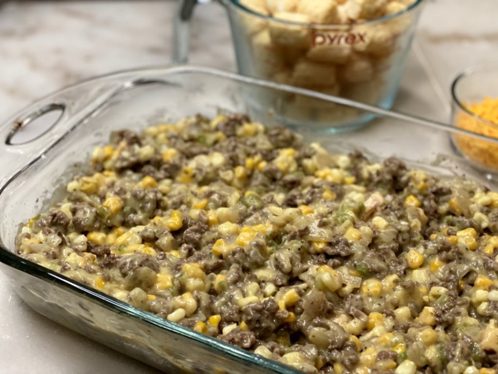 ground beef, corn, cream of chicken soup in a glass baking dish