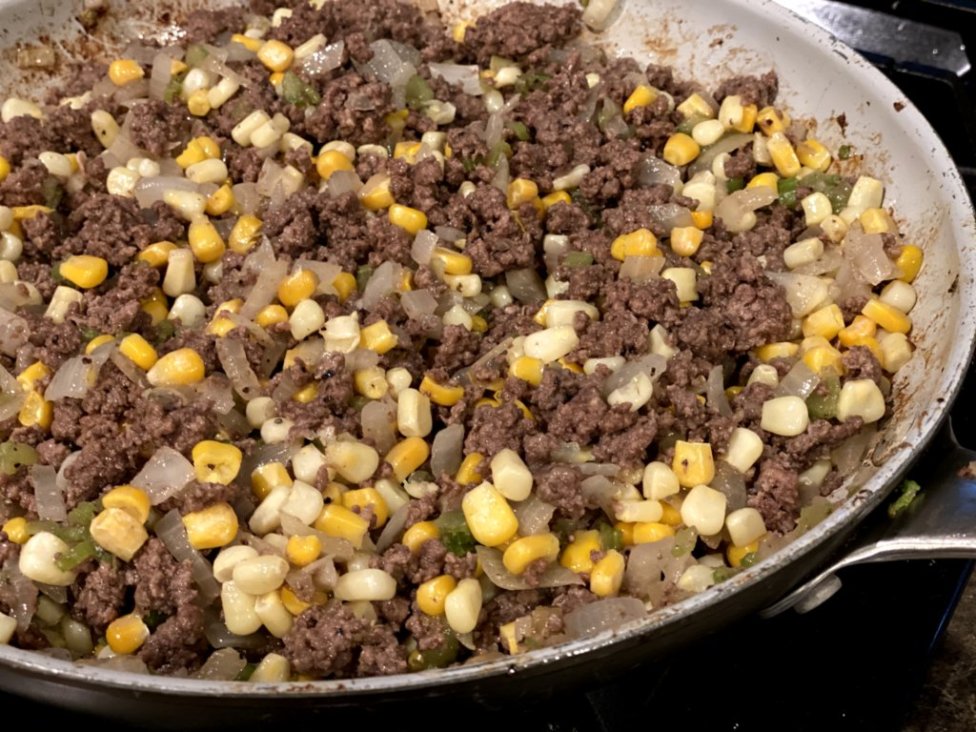 cooked ground beef with corn, onions, and garlic
