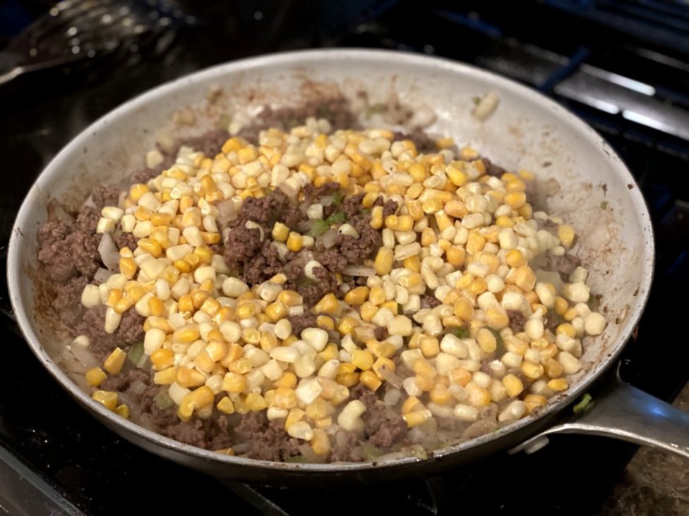 cooked ground beef with corn, onions, and garlic