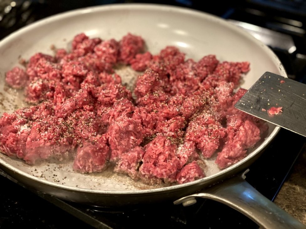 cooking ground beef in a large skillet with seasonings. 