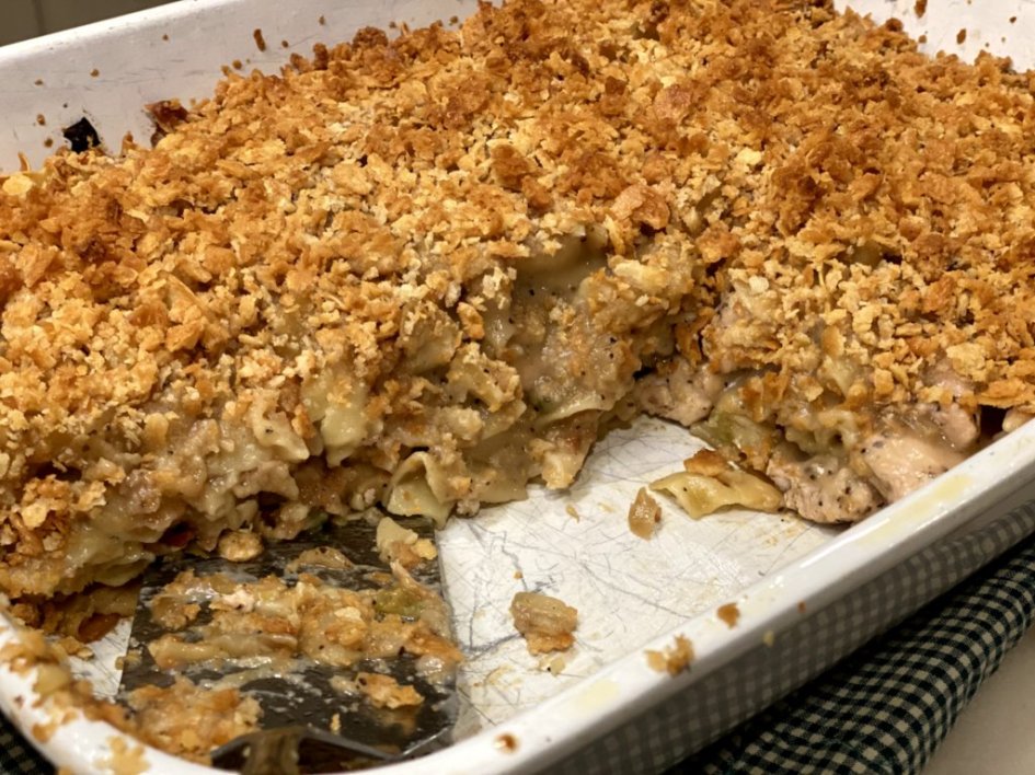 Baked chicken and noodles in a white casserole baking dish