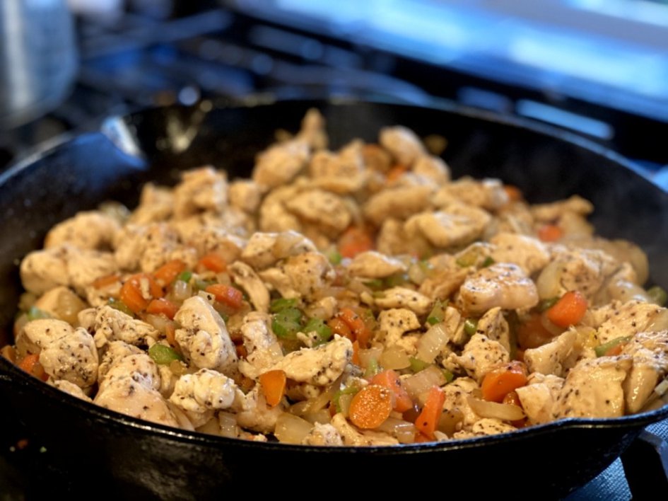 add the browned chicken to the cooked veggies in the skillet