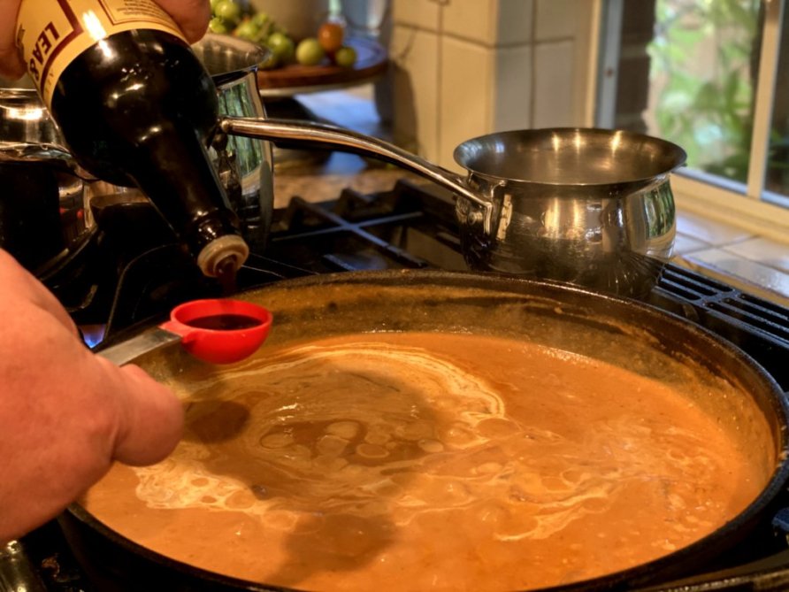 worcestershire sauce added to the stroganoff sauce with a measuring spoon