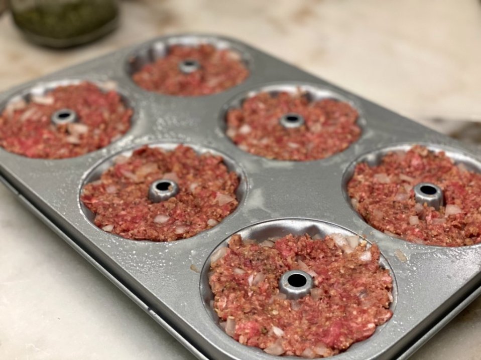 meatloaf cupcakes in a muffin pan, ready to bake