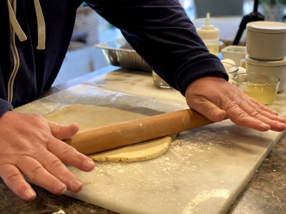 rolling out the crust for savory chicken and pork meat pie