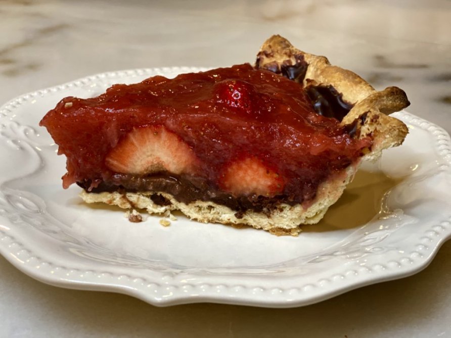 a slice of strawberry chocolate pie on a plate, ready to serve. 