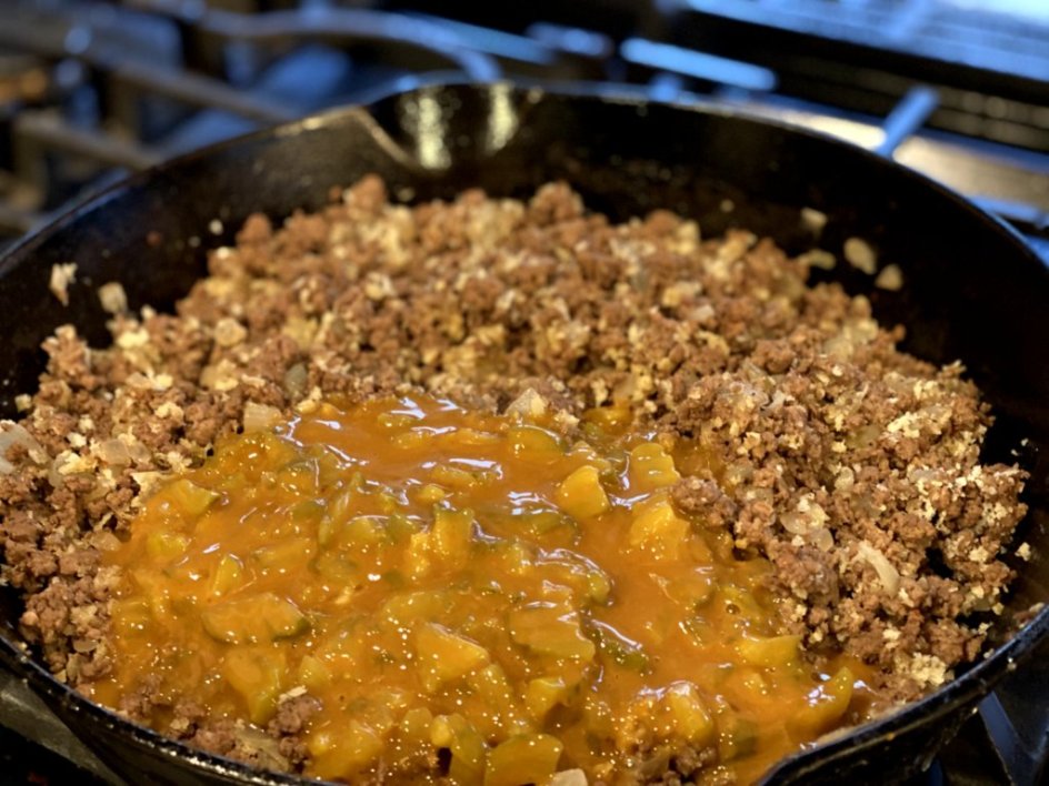 adding the sauce to the ground beef