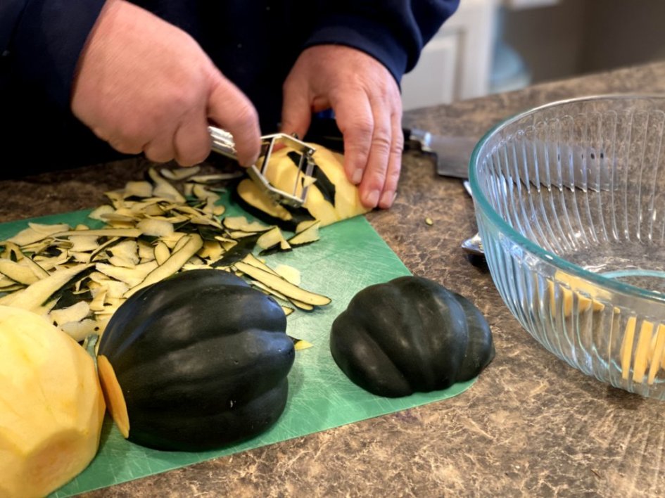 chef peeling acorn squash