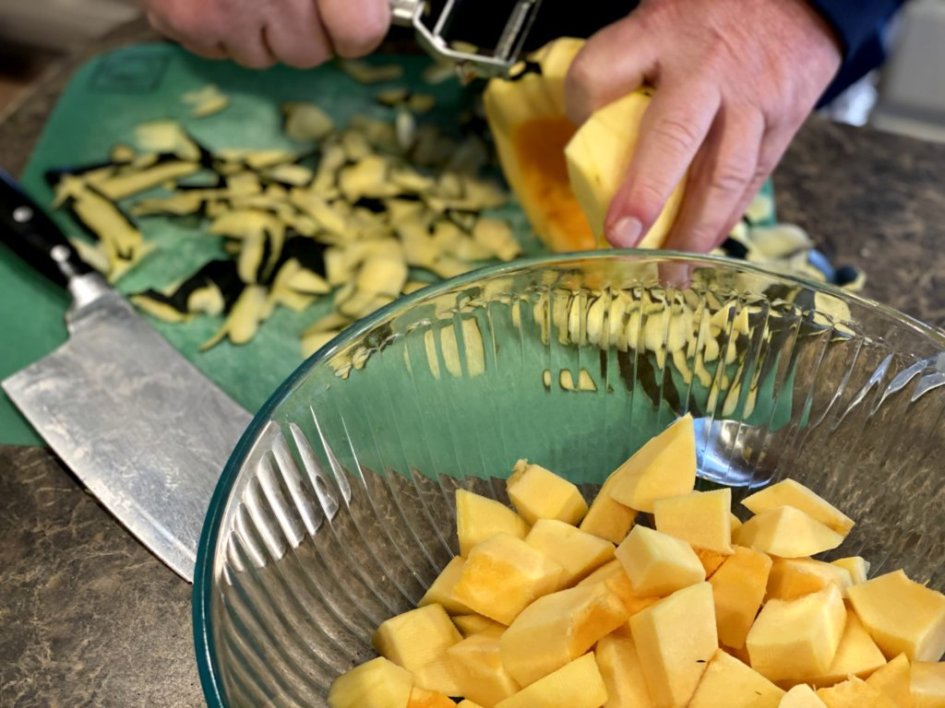 peeling acorn squash and cutting into cubes