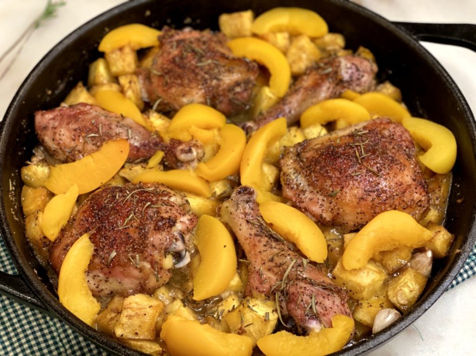 chicken, peaches, and squash baked in a cast-iron skillet.