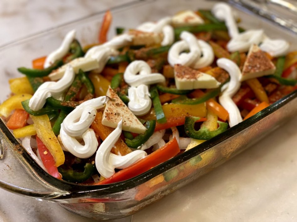 chicken fajita casserole with red bell peppers, green bell peppers, orange bell peppers, yellow bell peppers, jalapenos, sour cream and butter