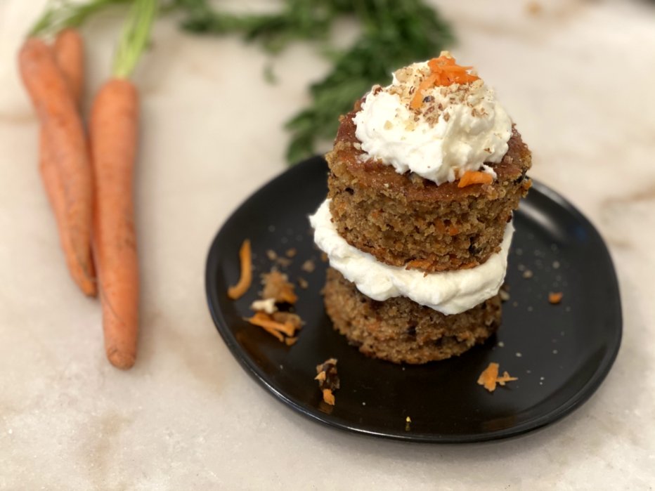 carrot cake double stacked muffins with cream cheese frosting and carrots. 