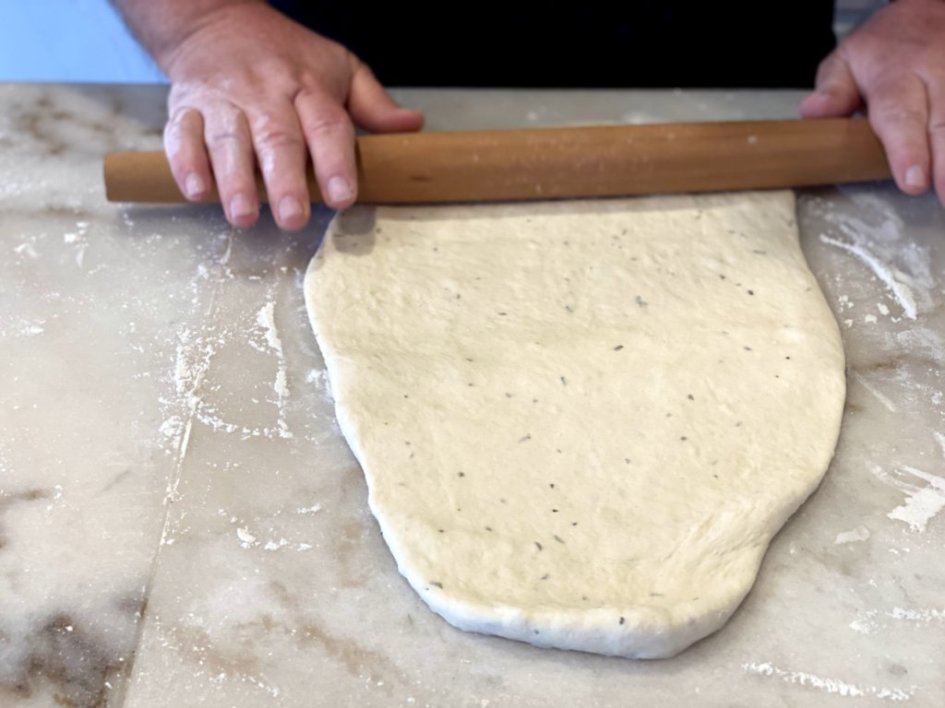 rolling out rosemary french bread dough