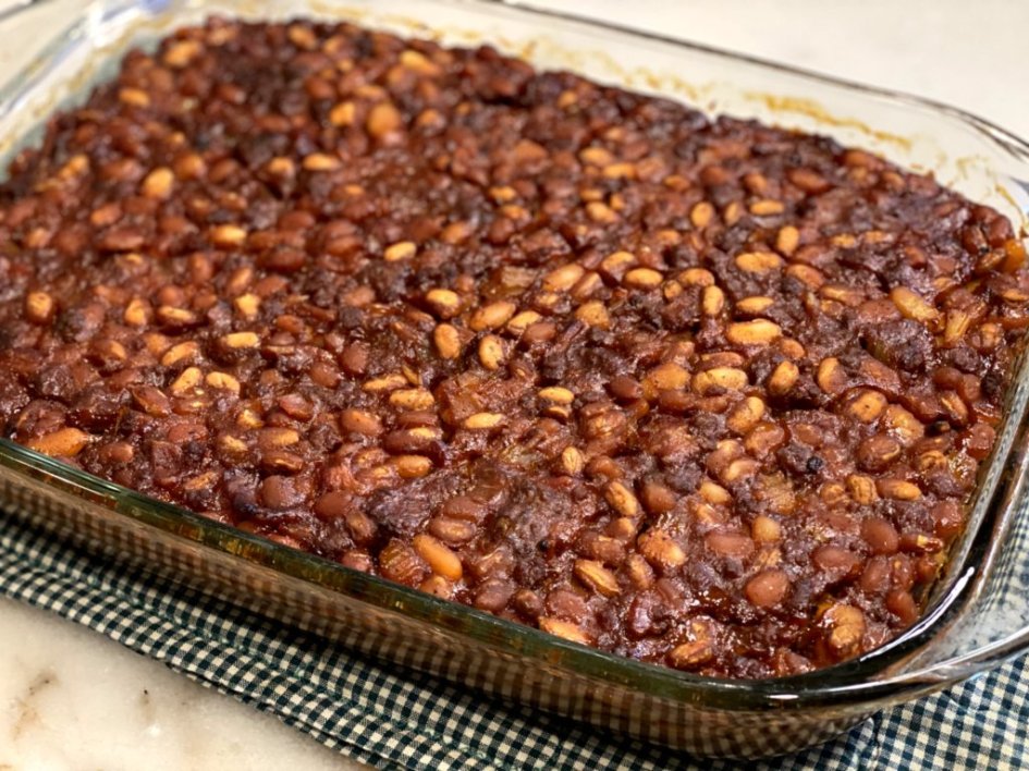 Sweet and savory baked beans casserole is ready to serve. 