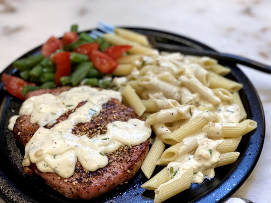 pork chops with garlic parmesan cream sauce and a side of green beans and roasted tomatoes. 
