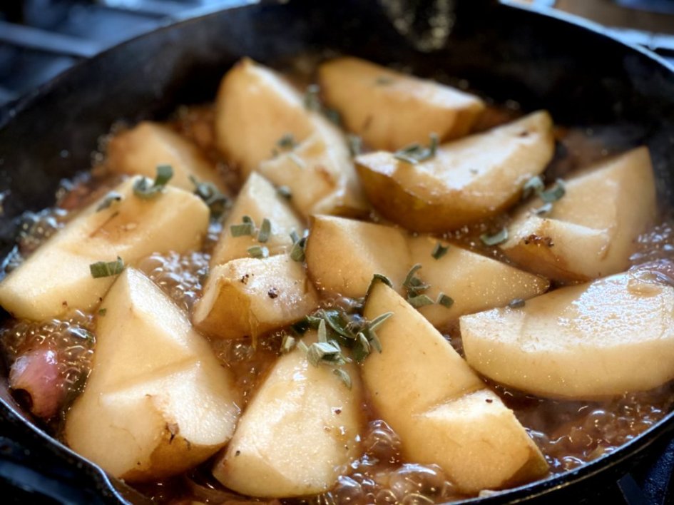 Cooking pears, shallots, sage, and ginger in a skillet. 