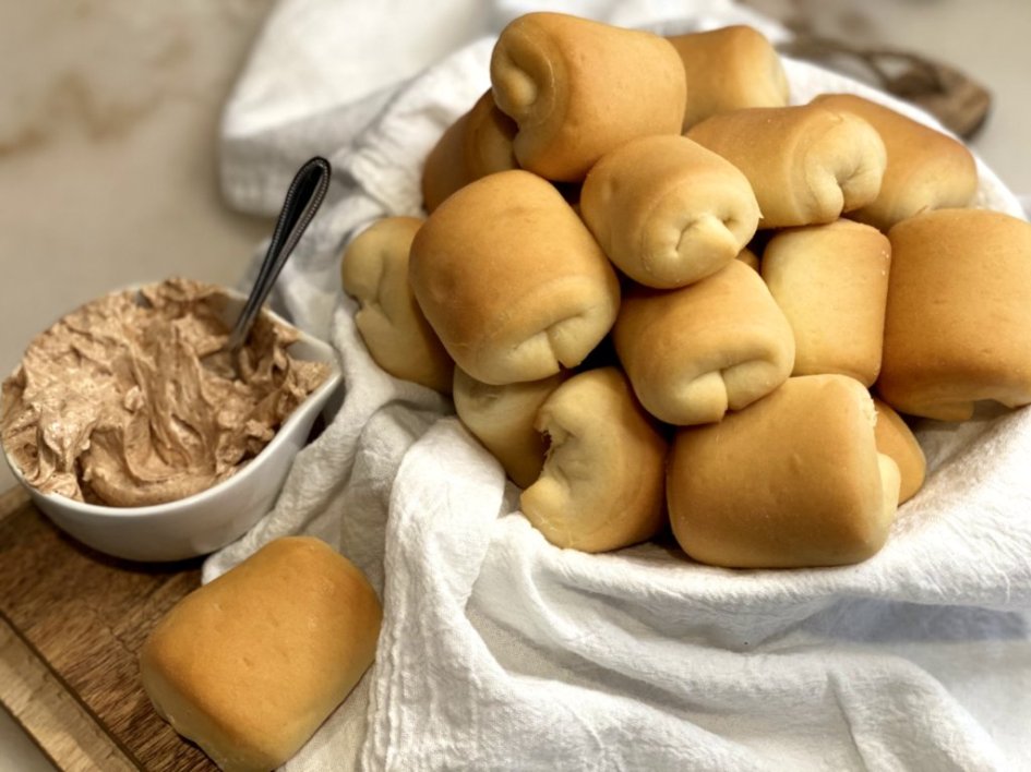 Texas roadhouse rolls with cinnamon honey butter Coogan's Kitchen Copycat Recipes - in a white bread basket