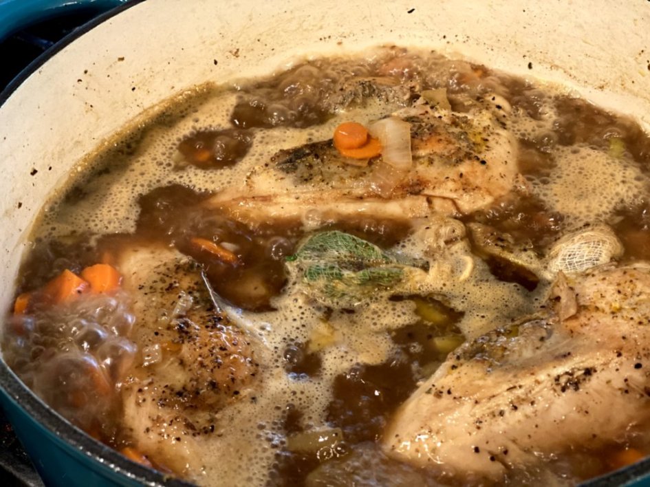 Chicken broth with herbs, vegetables, and chicken breast. 