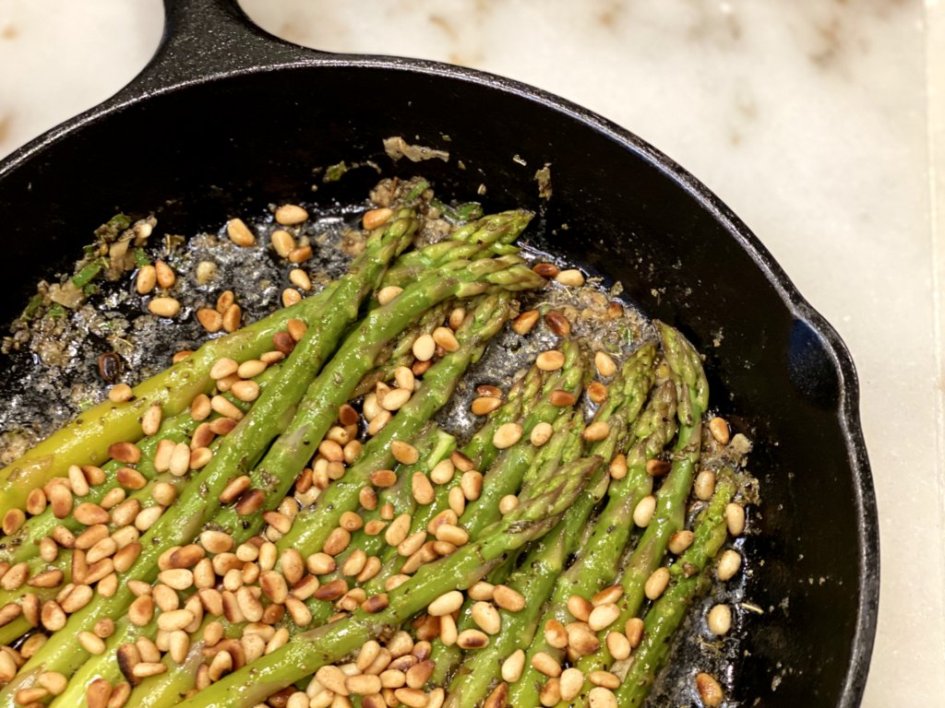 Asparagus drizzled in herb dressing sprinkled with toasted pine nuts.