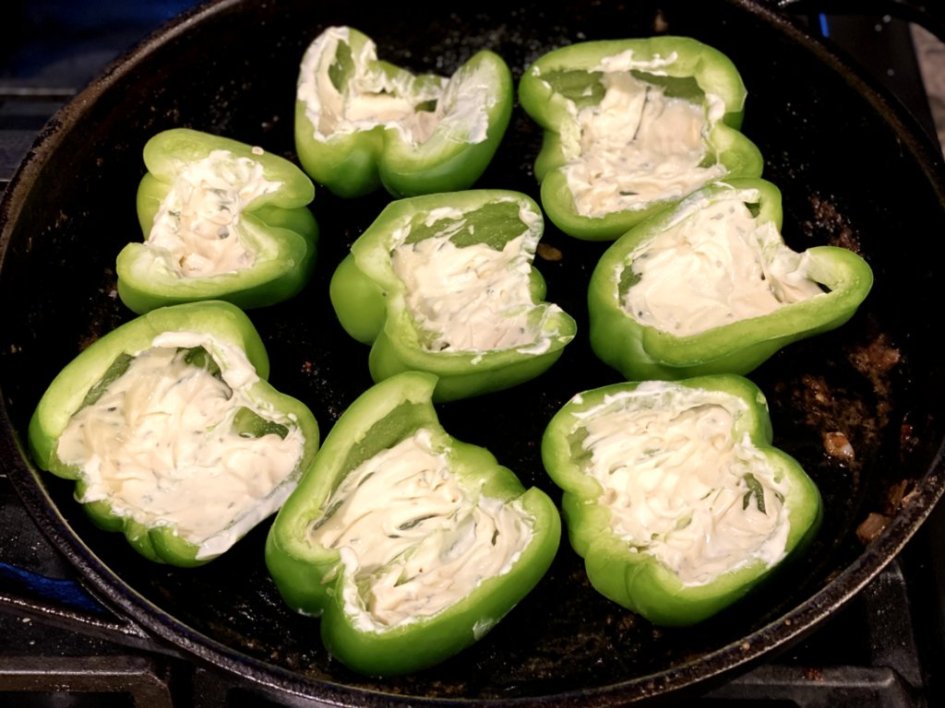 Scoops of garlic aioli sauce inside each of the green bell peppers. 