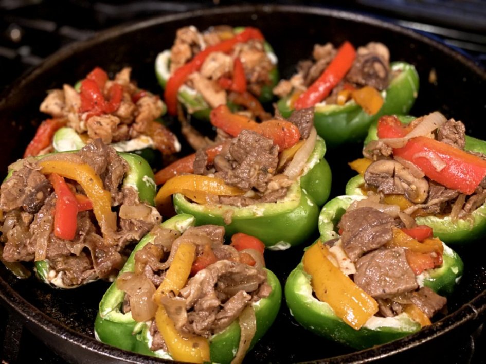 Halved green bell peppers stuffed with steak, peppers, and onions. 