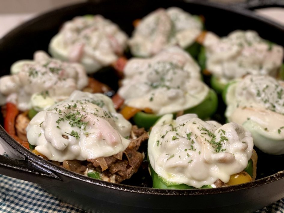 Delicious Philly Cheesesteak Stuffed Peppers baked in a cast-iron skillet. 