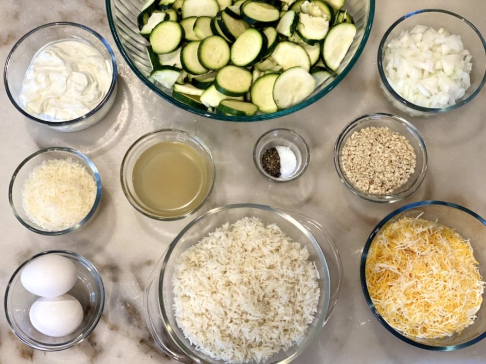 Ingredients needed for the zucchini casserole, placed in glass bowls. 