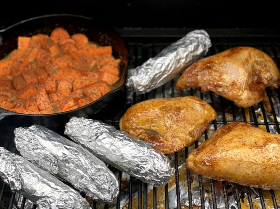 Easy sweet potate recipe on the grill with corn wrapped in foil and large chicken breasts. 