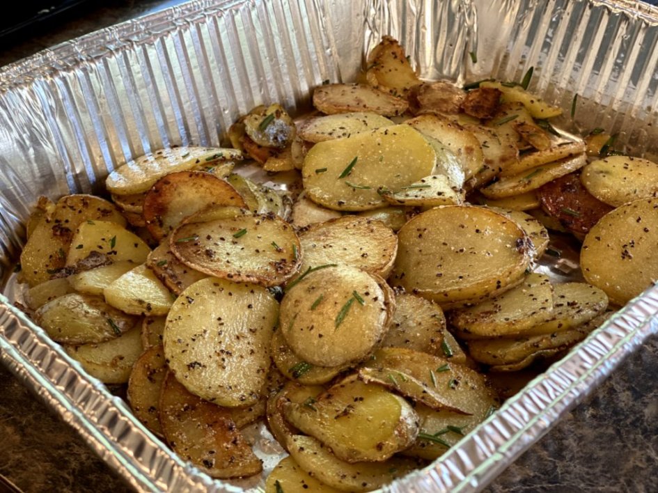 browned potato slices seasoned with salt and pepper and sprinkled with rosemary.
