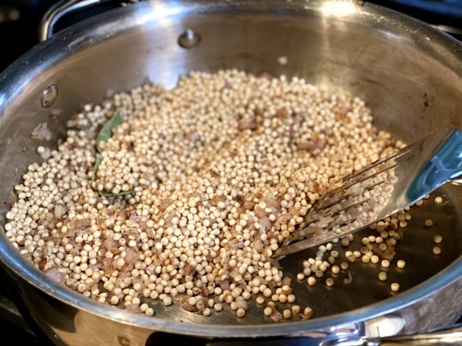 peal sized couscous added to a hot skillet with softened shallots cooked in butter. Stirring with a spatula until lightly browned. 