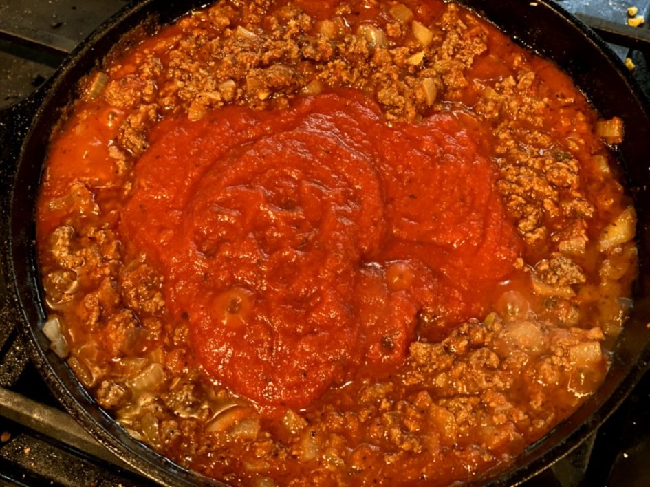 homemade meat sauce cooked in a cast iron skillet