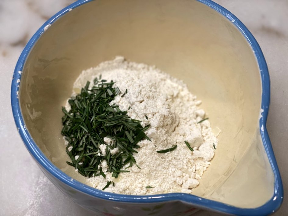 chopped rosemary and baking mix in a mixing bowl. 