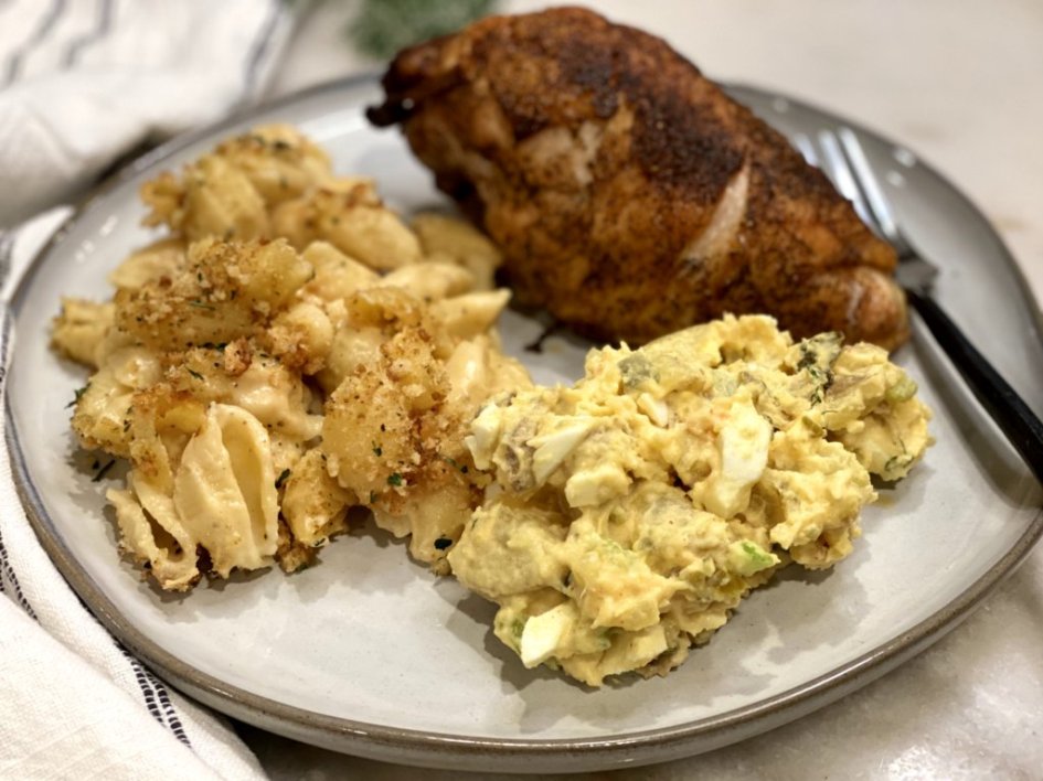 Creamy southern potato salad served with grilled chicken and macaroni and cheese.