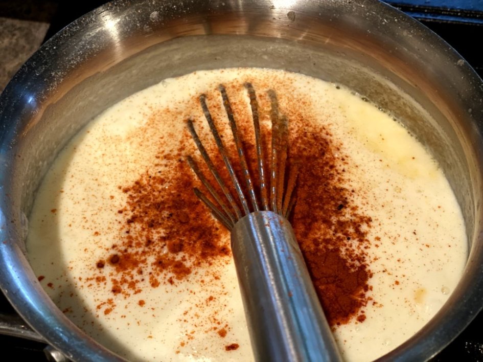 Making cheese sauce with paprika for homemade macaroni and cheese. 