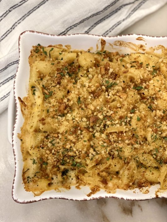 Homemade macaroni and cheese fresh from the oven sprinkled with seasonings and bread crumbs. 