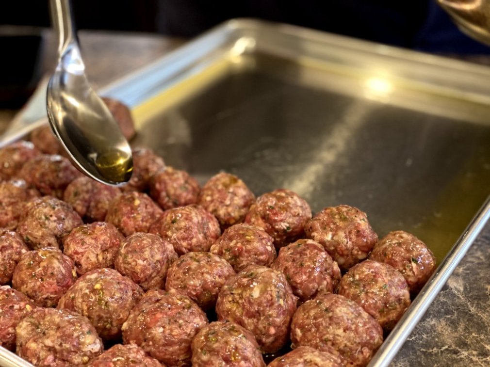 drizzle olive oil over the prepared homemade meatballs