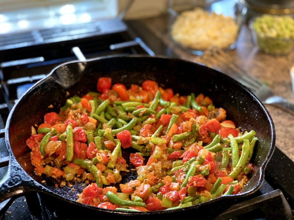 Chef adds the seasonings plus salt and pepper to the skillet of vegetables to make an easy succotash. 