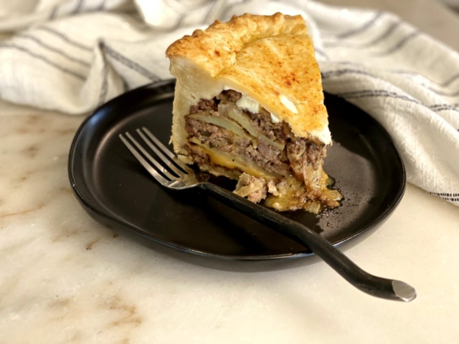beef pie with layers of cheese, meat, and potatoes. 