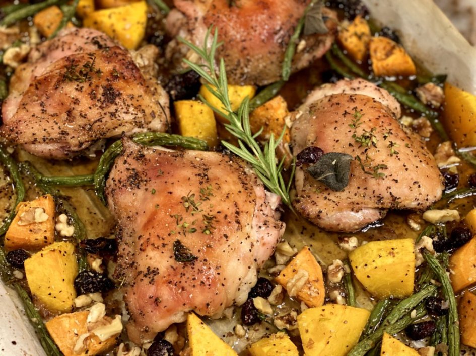 Autumn Roasted Chicken and Vegetables fresh out of the oven on a sheet pan with butternut squash, sweet potatoes, walnuts, cranberries, rosemary and sage. 