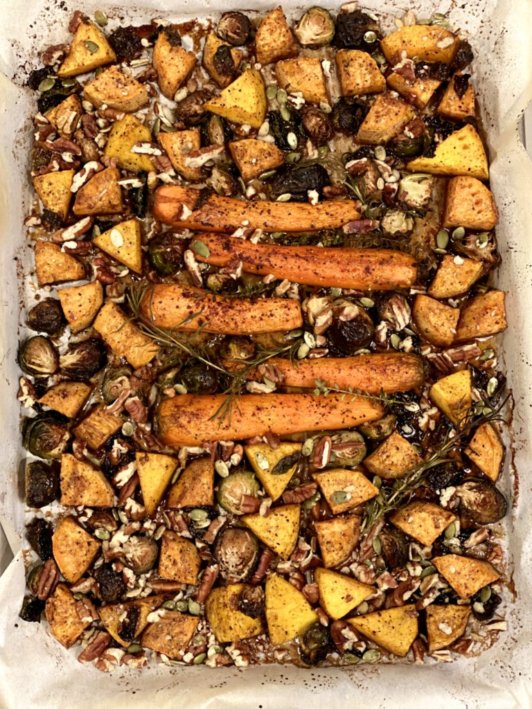 Maple Pecan Roasted Vegetables on a sheet pan covered in a maple syrup glaze 