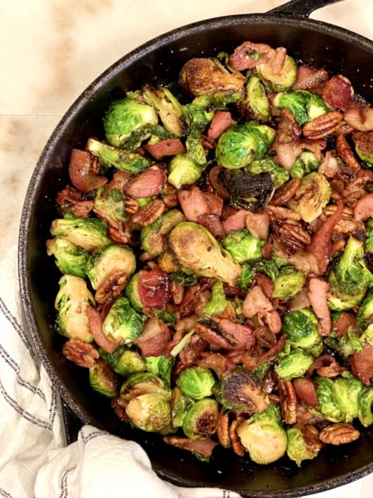Easy brussels sprouts recipe with maple syrup, cloves, pecans and bacon. 