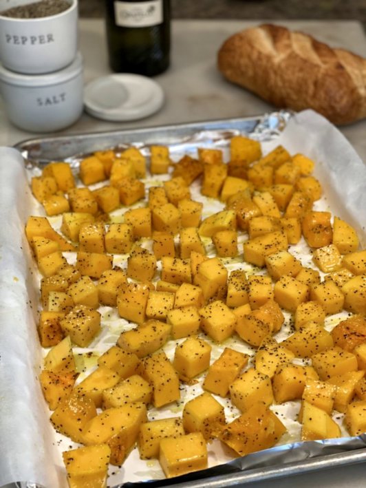 roasting chunks of butternut squash sprinkled with salt and pepper in the oven